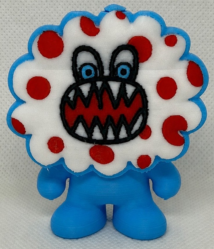 Finished 3D print of a blue fluffy monster with big eyes and red polka dots