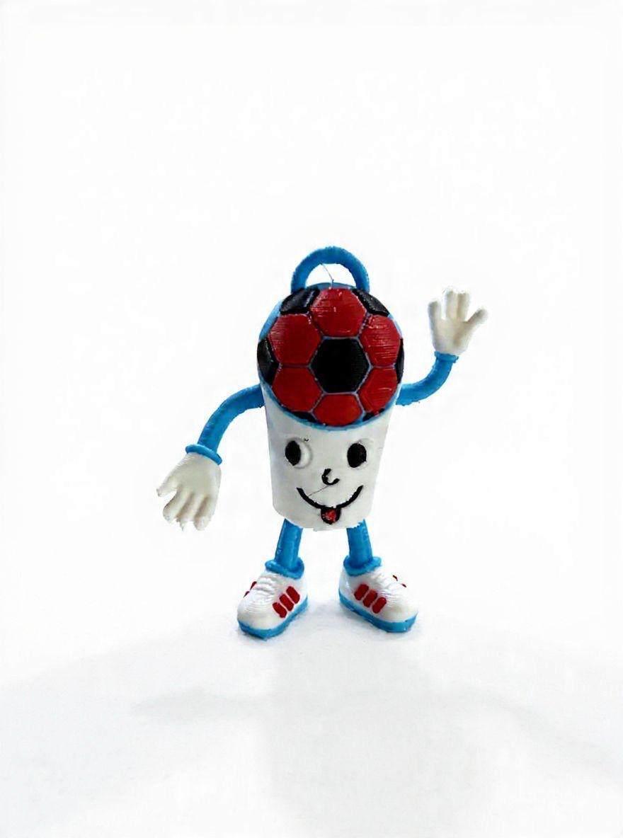 Painted 3D-printed figurine of a waving soccer-ball-headed mascot with a cup-shaped body